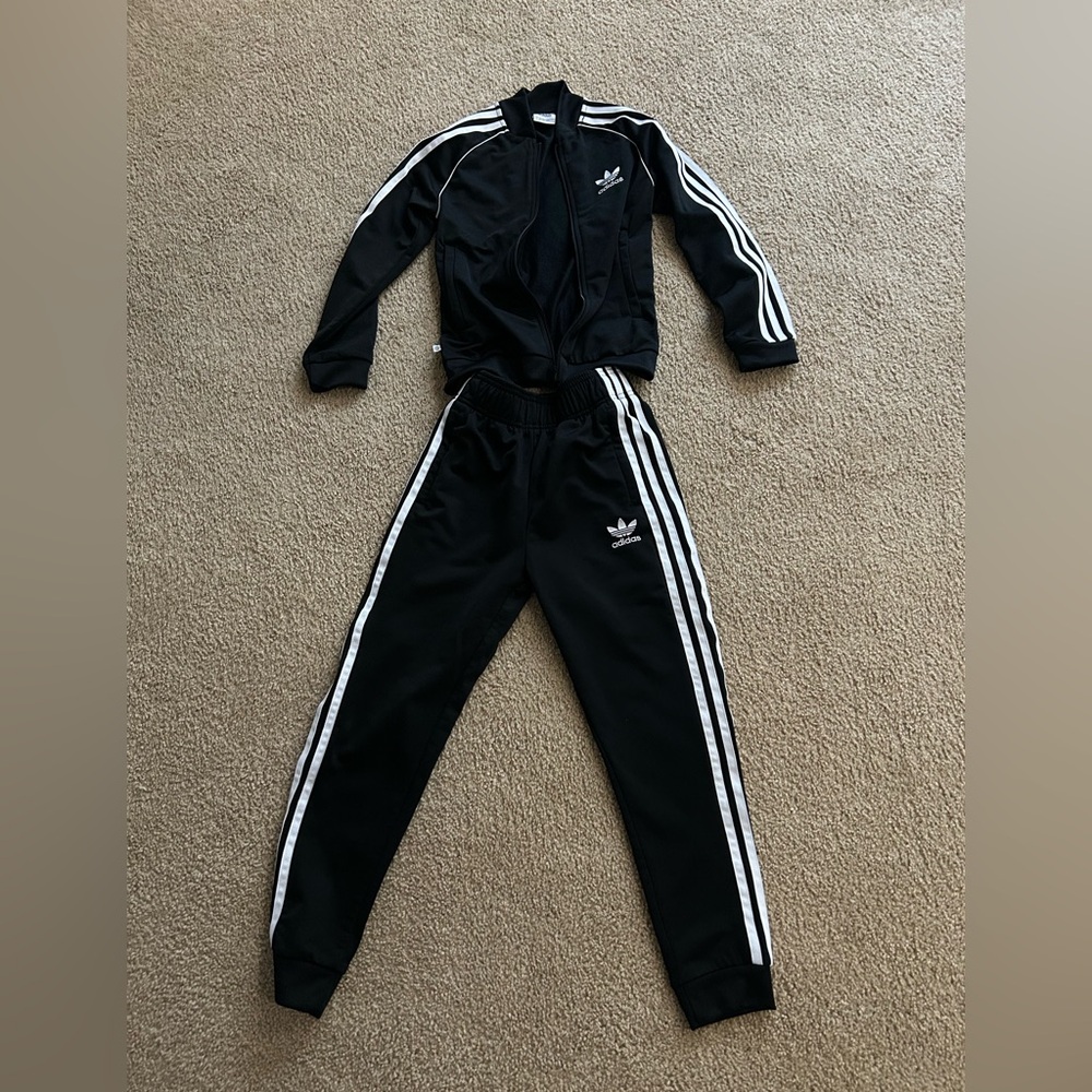 Black adidas track suit.